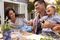 A family is having a picnic in their backyard.